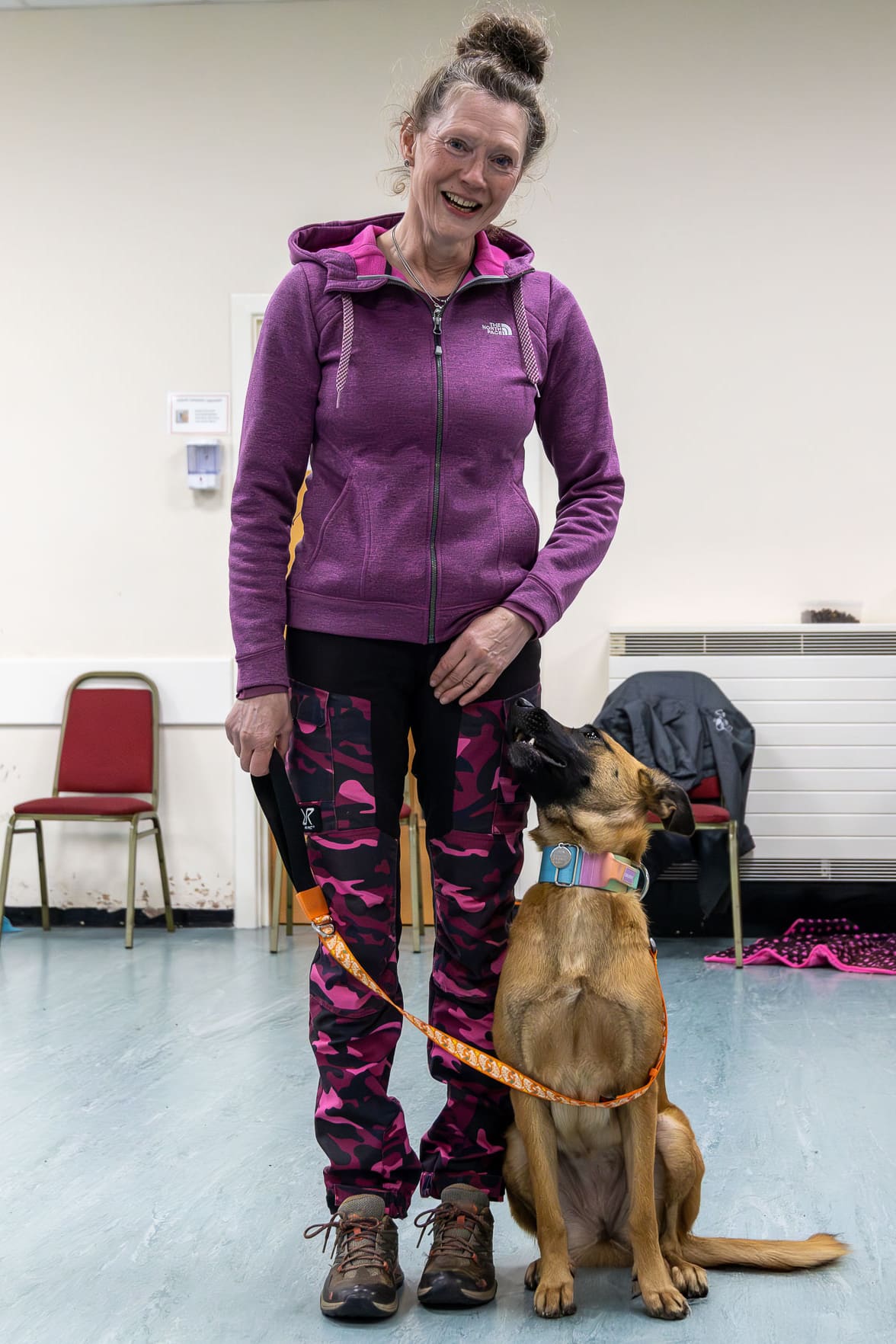 A proud dog owner smiles with her dog during training at Curlabull Dog Training in Leadgate, Consett – building trust and teamwork.