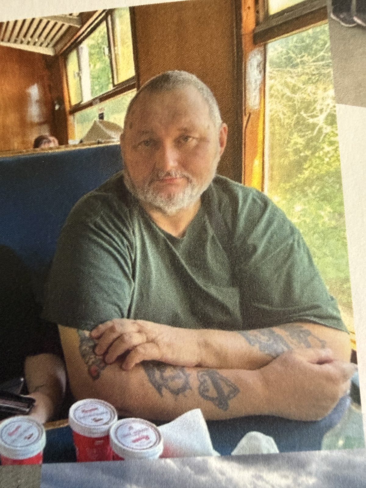 Stephen before his weight loss, sitting at a table by a window
