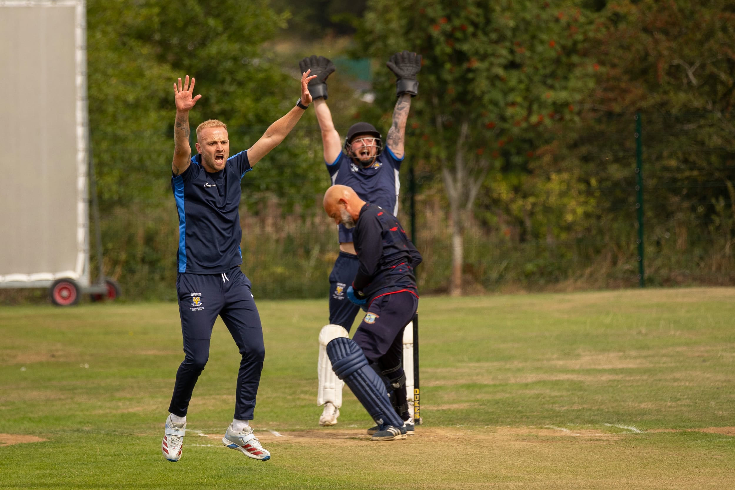 A bowler and fielders appealing for a wicket during a match at Lanchester Cricket Club.