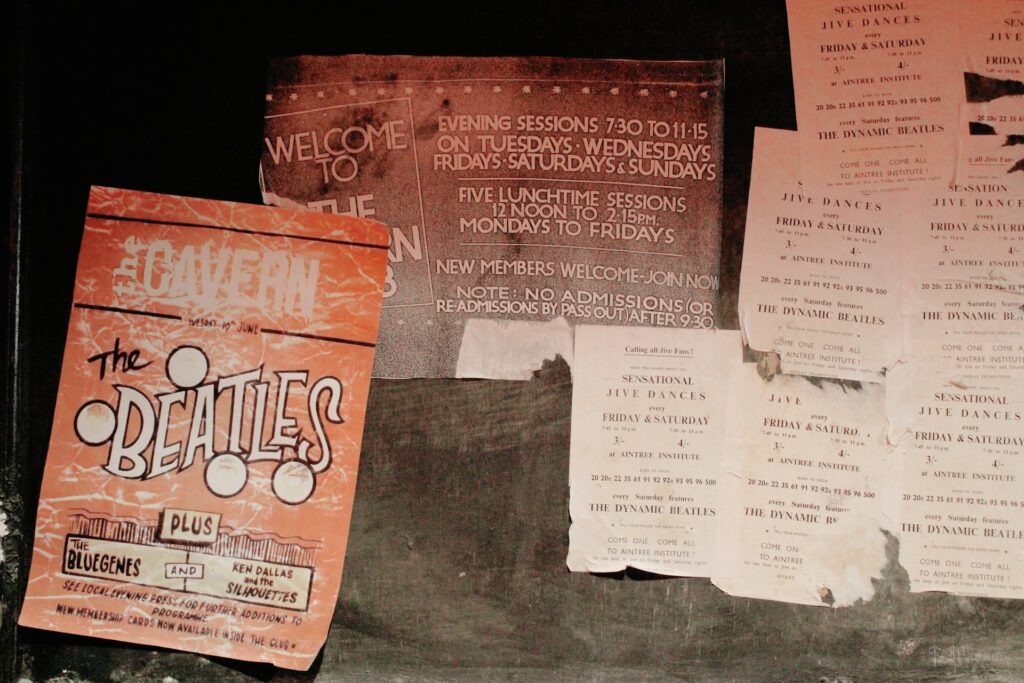 Vintage Beatles posters and flyers covering a wall in Liverpool.
