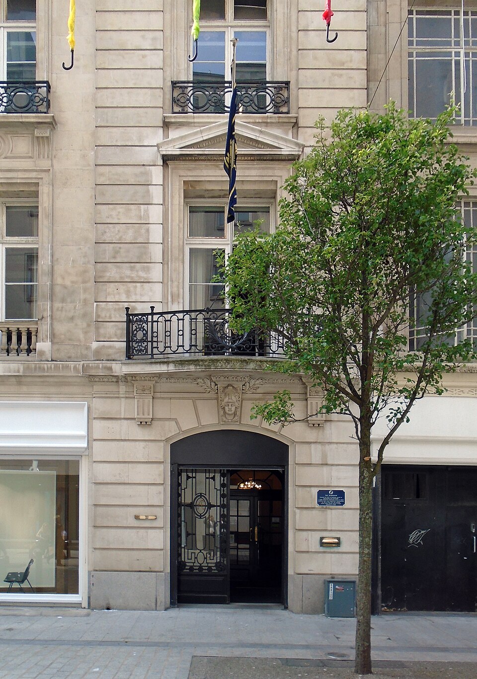 Main doorway of the Liverpool Athenaeum with decorative stonework and a dark iron gate.