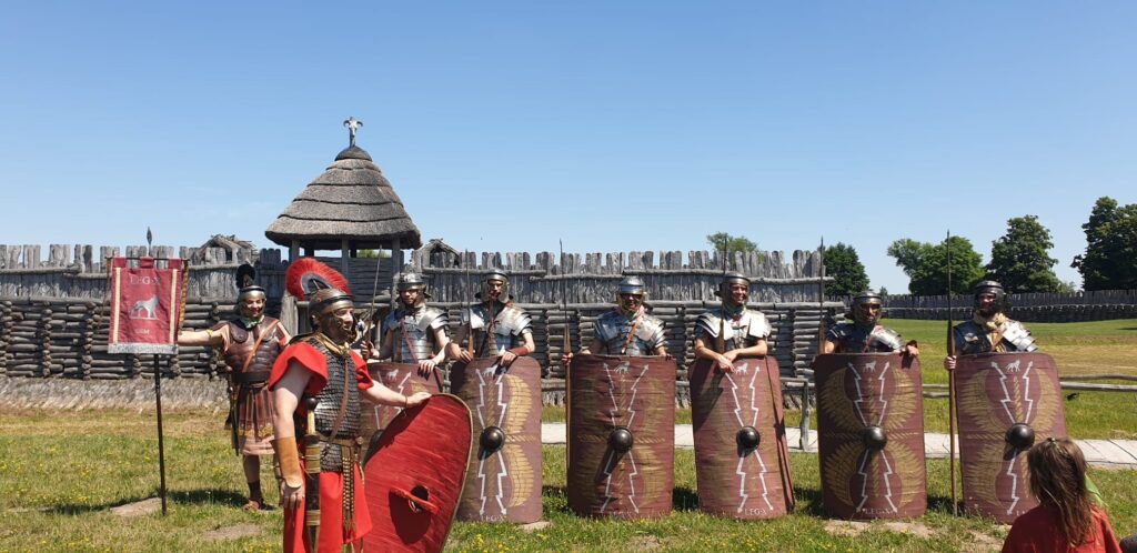 Current image: Members of Poznań's Legion X historical re-enactment group demonstrate Roman military formations at the Archaeological Museum in Biskupin